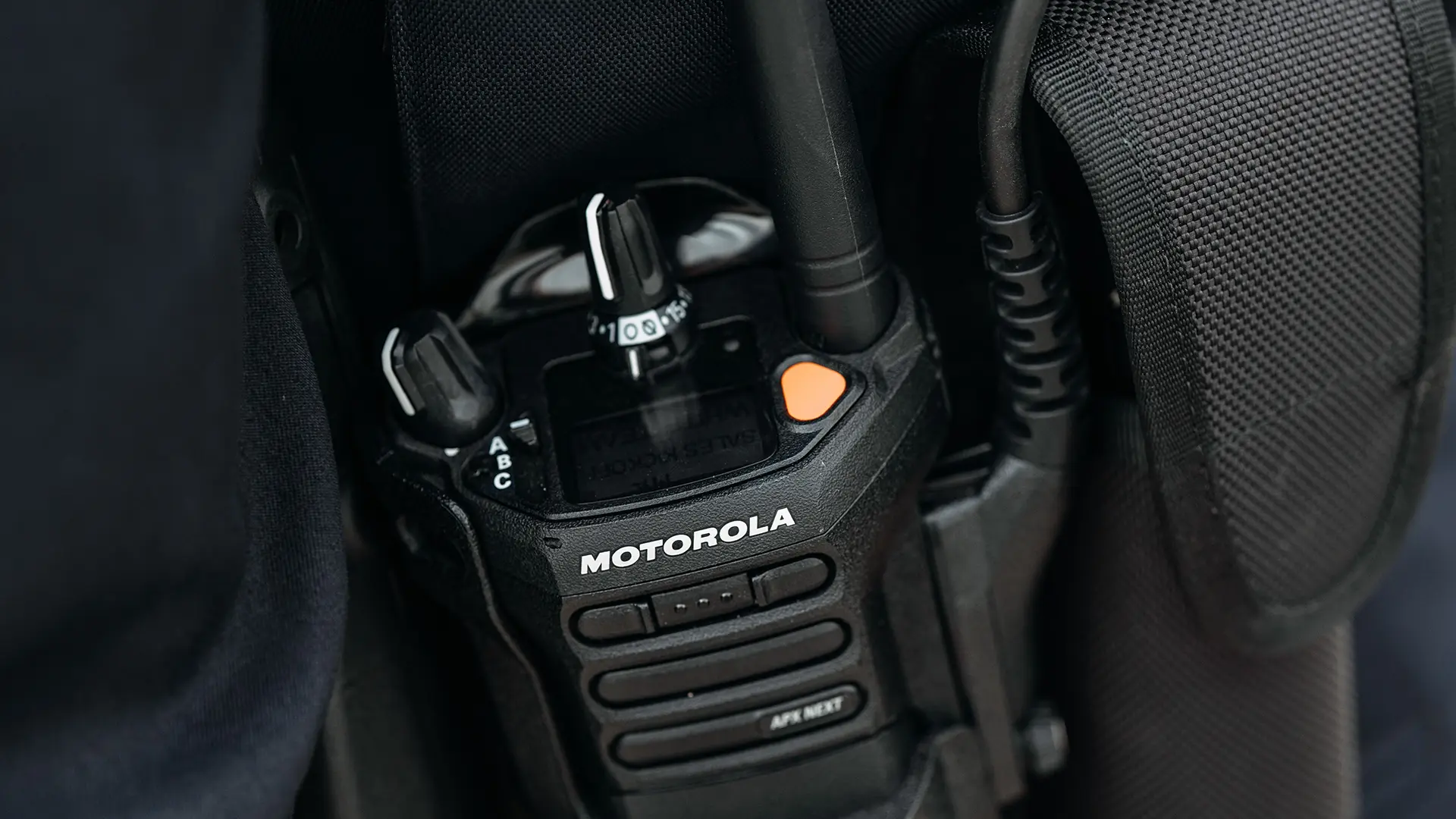 Close-up of Motorola Solutions two-way radio secured in black fabric holder