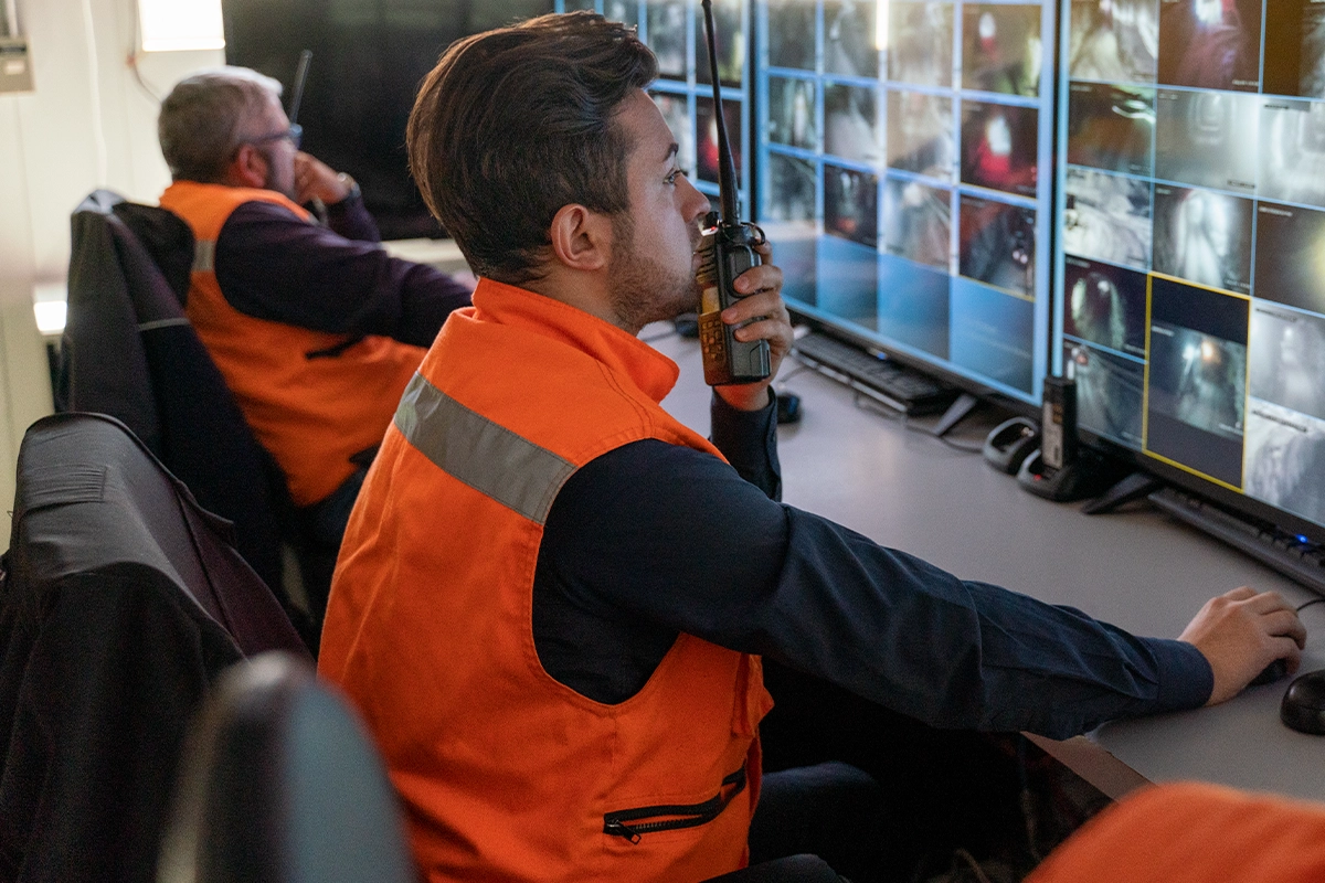 Transport control room operator using Motorola Solutions Two Way Radio to communicate with field teams